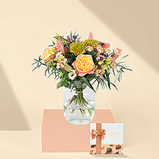 This exquisite hand-created bouquet of antique salmon and pink blossoms is so beautiful that it belongs in a painting. The freshest flowers are delivered daily from the flower auctions in Amsterdam to ensure that each blossom is picture-perfect. The six piece Neuhaus Discovery box features 6 iconic milk, dark, and white Belgian chocolates filled with delicious praliné, ganache, gianduja, and caramel.