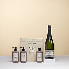 Presenting a gift set for pure pampering by the luxurious French brand Atelier Rebul. A stylish gift box with hand soap, shower gel, and lotion is paired with delicious Francesc Ricart Brut cava for a delightful experience.