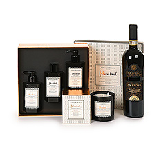 A luxurious gift box with a divine smelling scented candle and gift box with body care products from Atelier Rebul, a bottle of red Amarone Valpolicella wine.